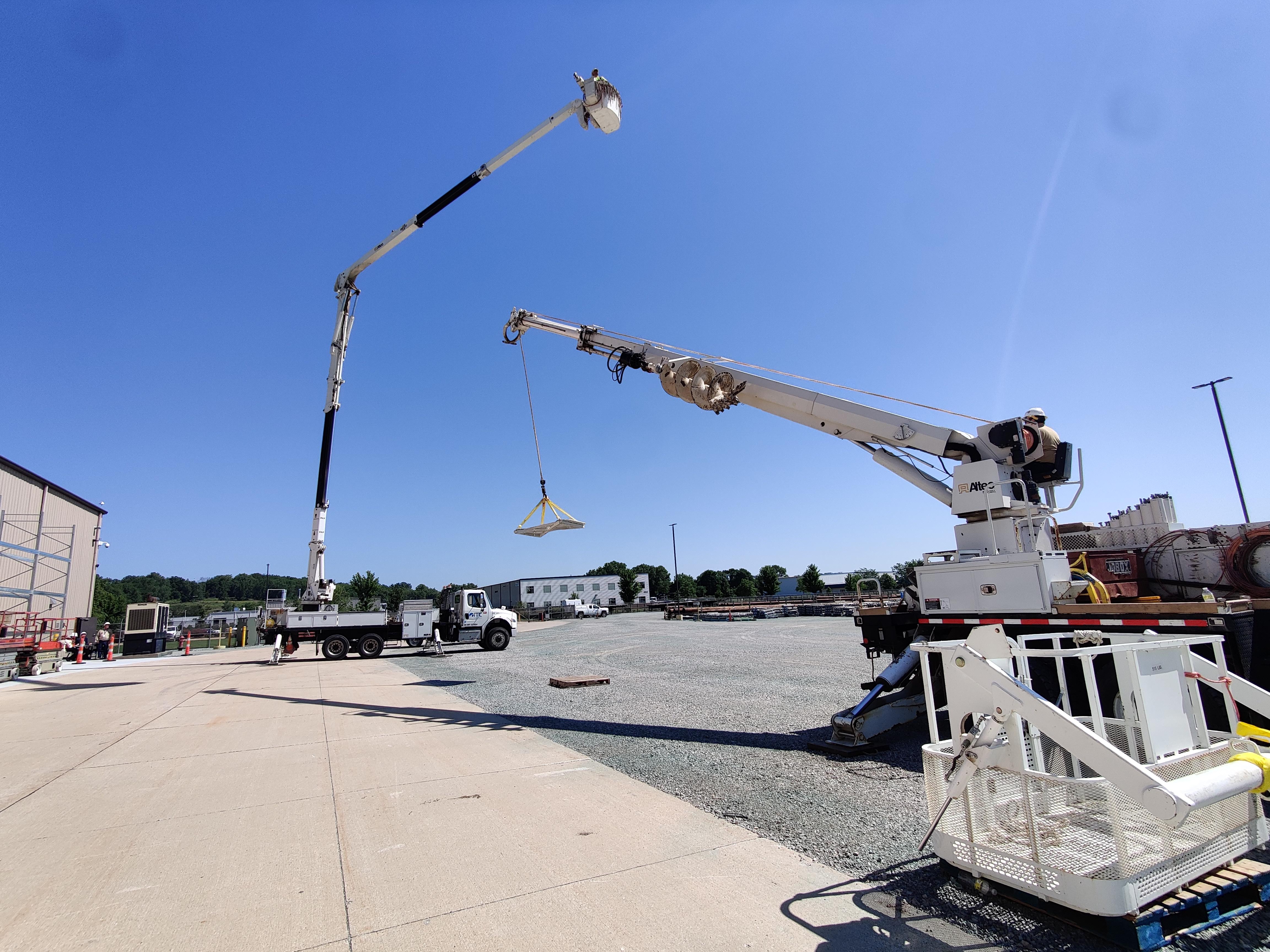A photo of a bucket truck and mobile crane.